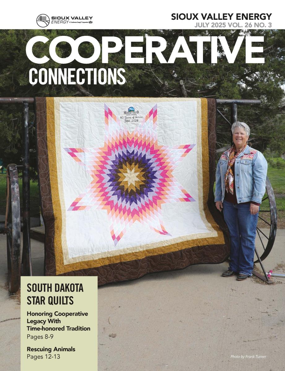 July 2025 magazine cover featuring woman standing next to a star quilt