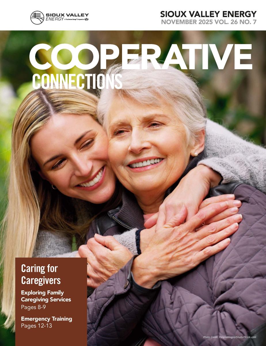 Cover of November 2025 magazine showing a younger woman embracing an older woman