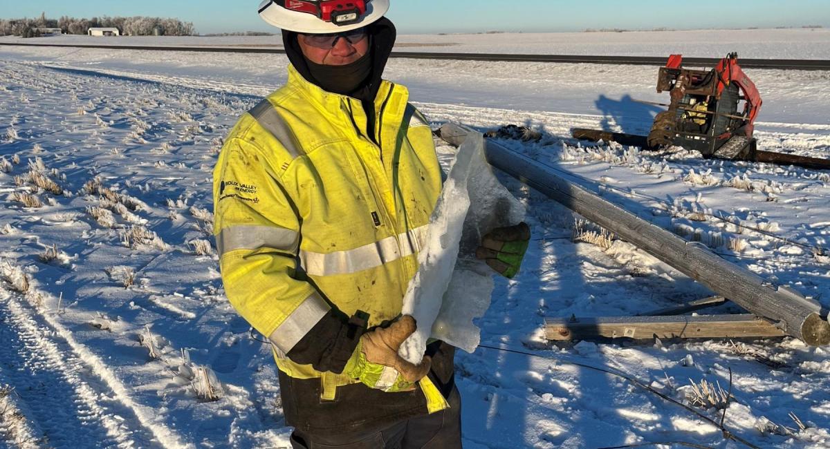 Lineworker holding ice chunk